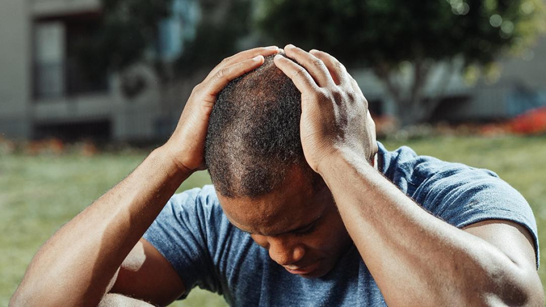 man holding his head