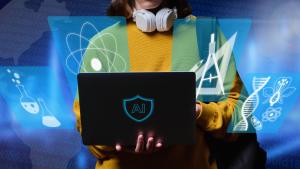 student holding laptop