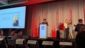 award stage with speaker and award winner Elizabeth Cauffman
