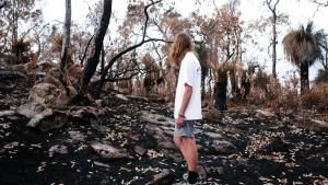 man looking at wildfire devastation